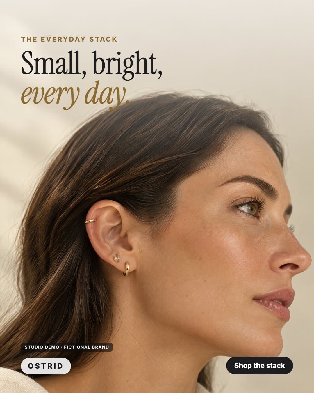 OSTRID ad: a side profile with a small gold ear stack, headline Small, bright, every day (studio demo, fictional brand)