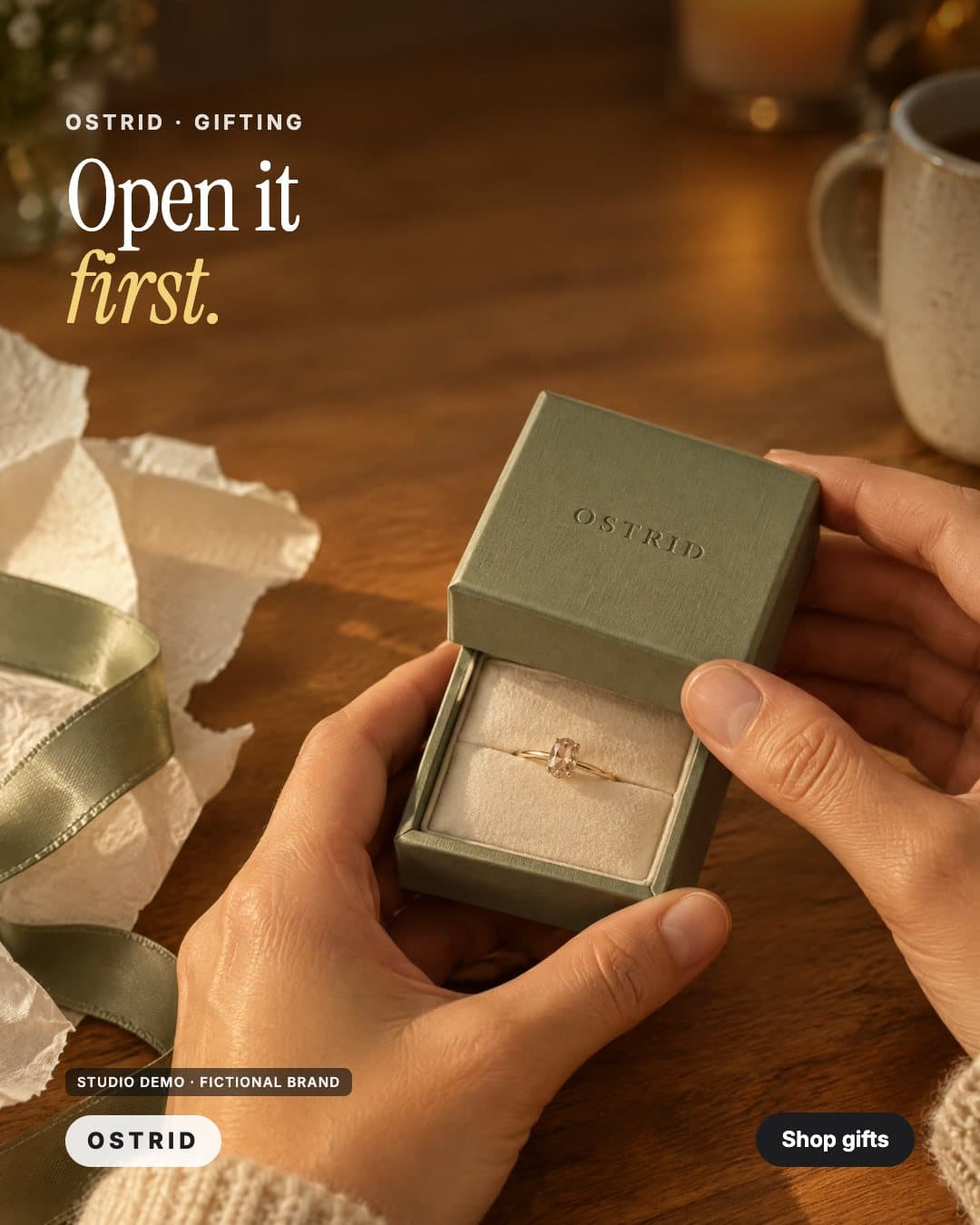 OSTRID ad: two hands open a sage-green ring box at a kitchen table, headline Open it first (studio demo, fictional brand)