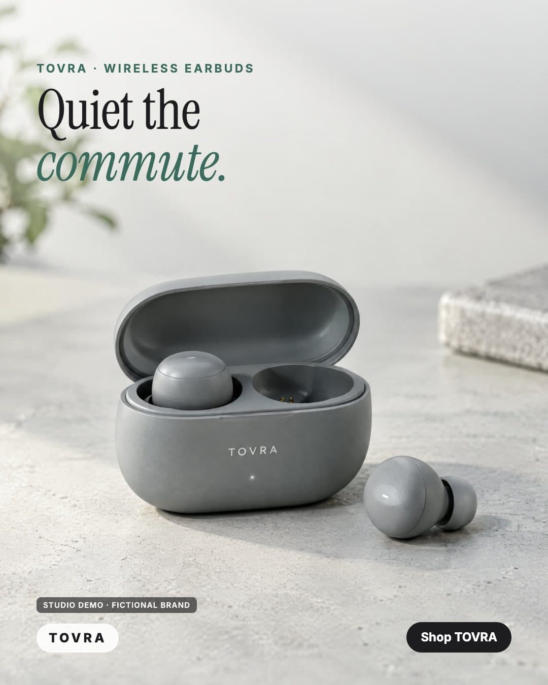 TOVRA ad: stone-grey wireless earbuds in an open case on a concrete desk (studio demo, fictional brand)