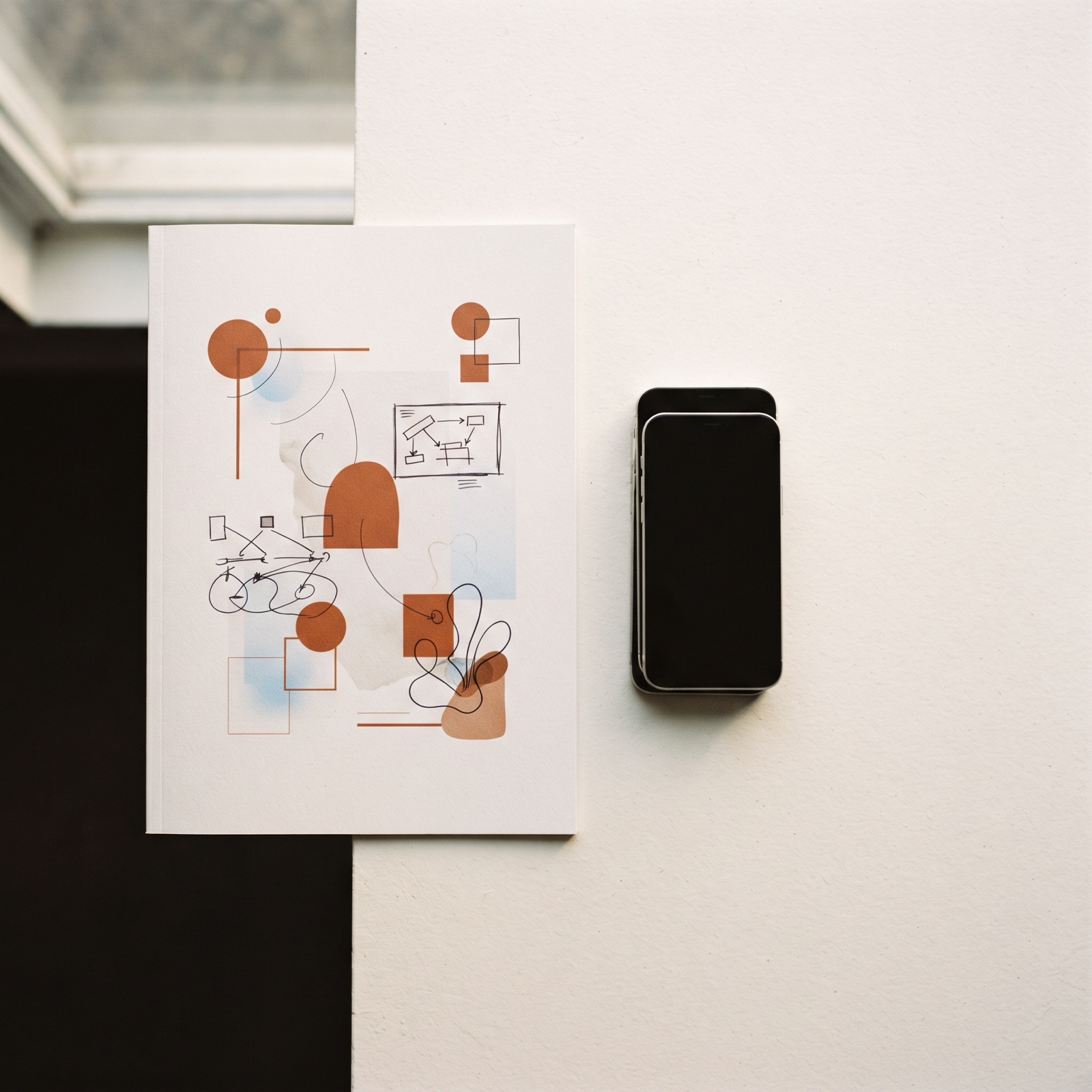 Flat lay of a printed cost report next to a stack of vertical phone mockups showing native Reels ad frames.