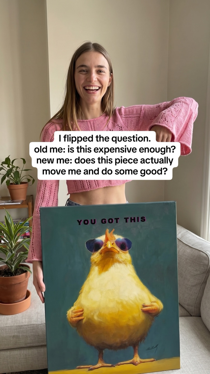 Andy Okay carousel slide: a laughing woman in a pink knit sweater points at a YOU GOT THIS canvas of a yellow chick in sunglasses