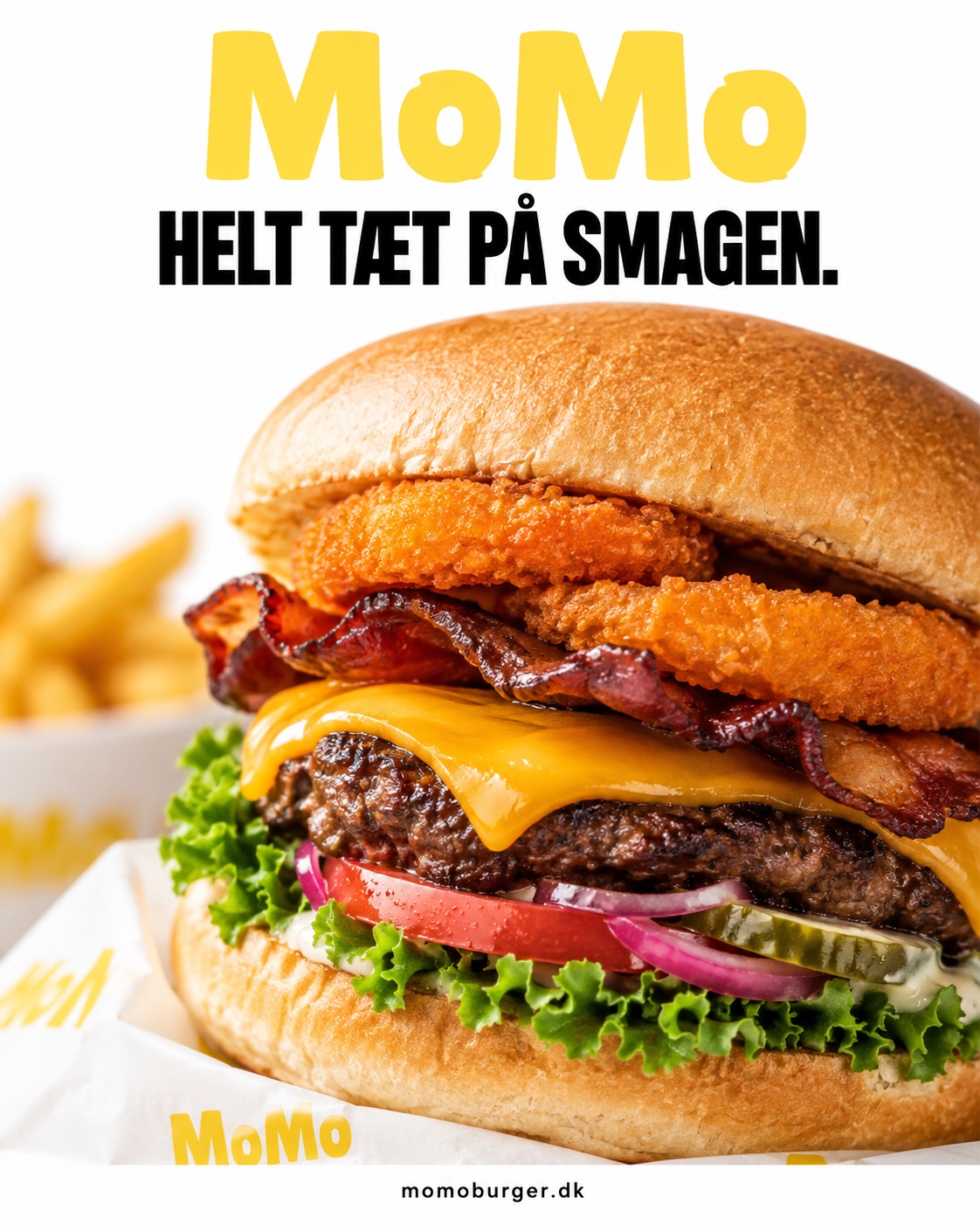 MoMo campaign key visual: the loaded bacon and onion ring burger in its wrapper, headline 'MoMo. Helt tæt på smagen.'