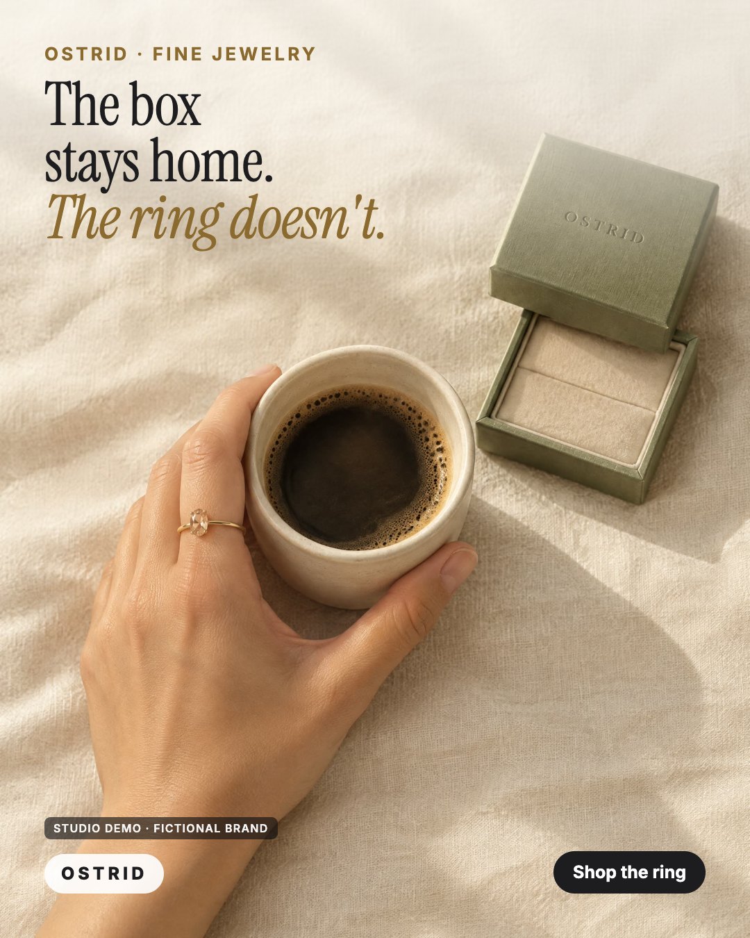 AI-generated studio demo Feed ad for the fictional jewelry brand OSTRID: seen from above, an empty sage-green ring box on linen beside a hand wearing the ring and holding a coffee cup, headline The box stays home. The ring doesn't