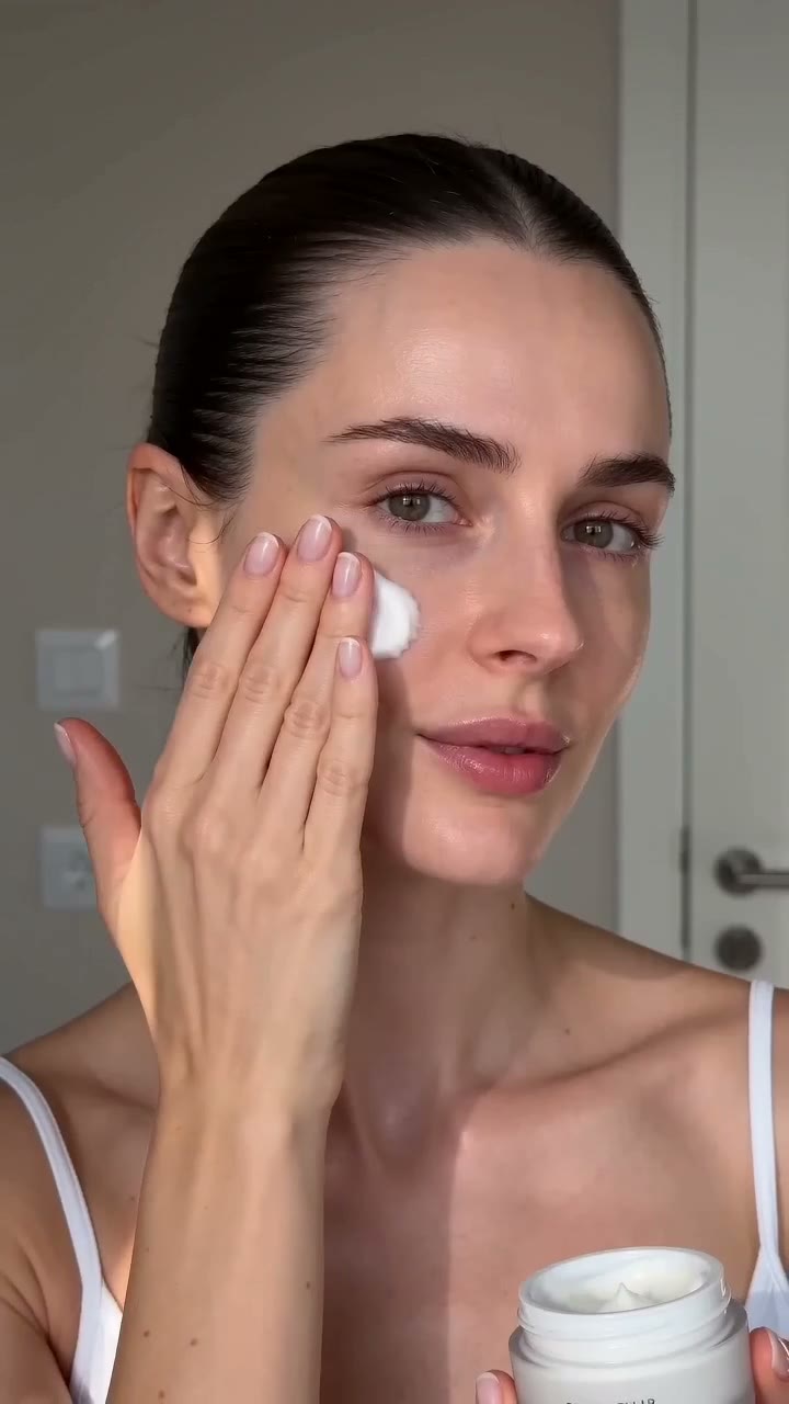Morning skincare routine, woman applying cream. AI-generated beauty reel